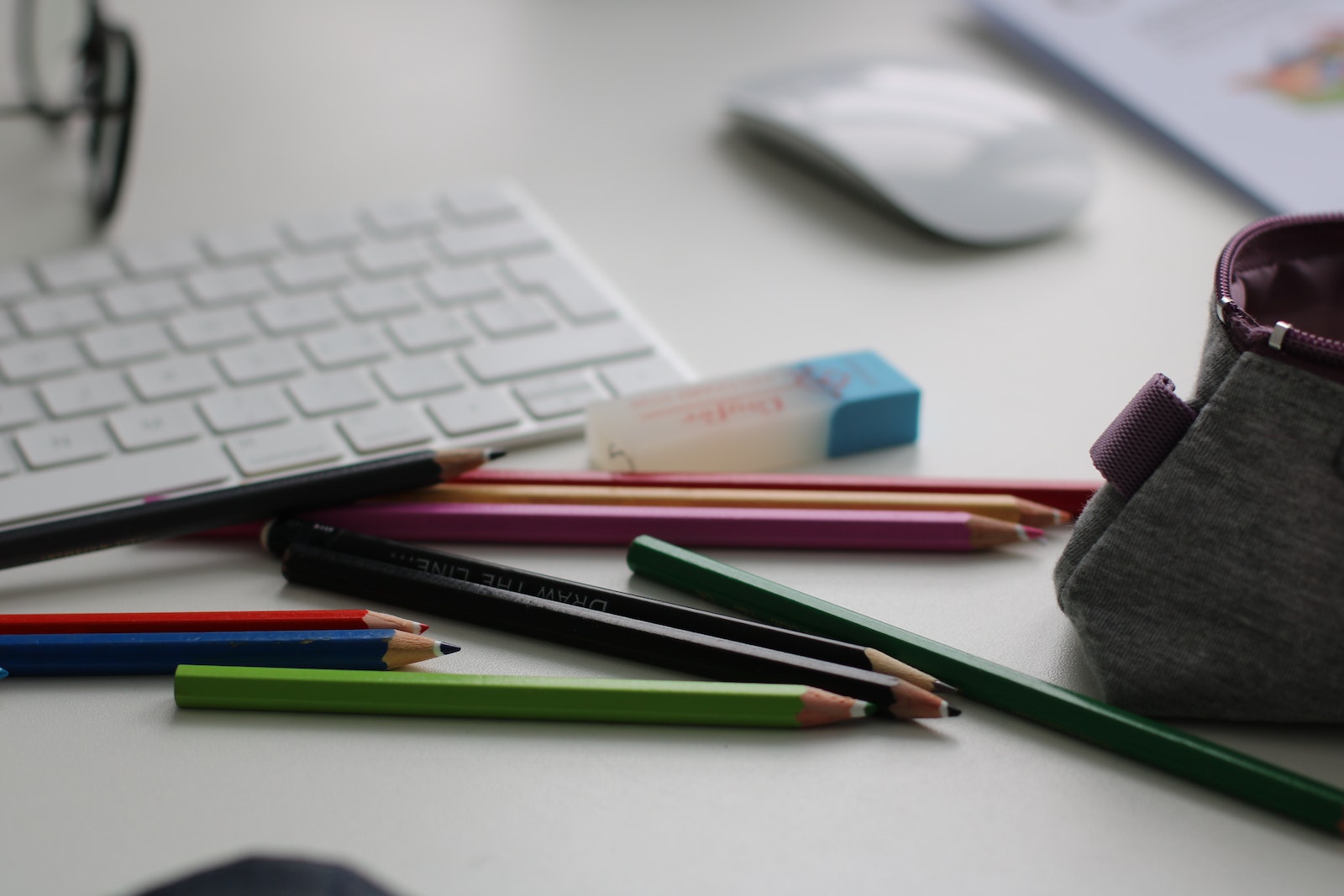 Shallow Focus Photography of Assorted Pencils Near Apple Keyboard and Mouse
